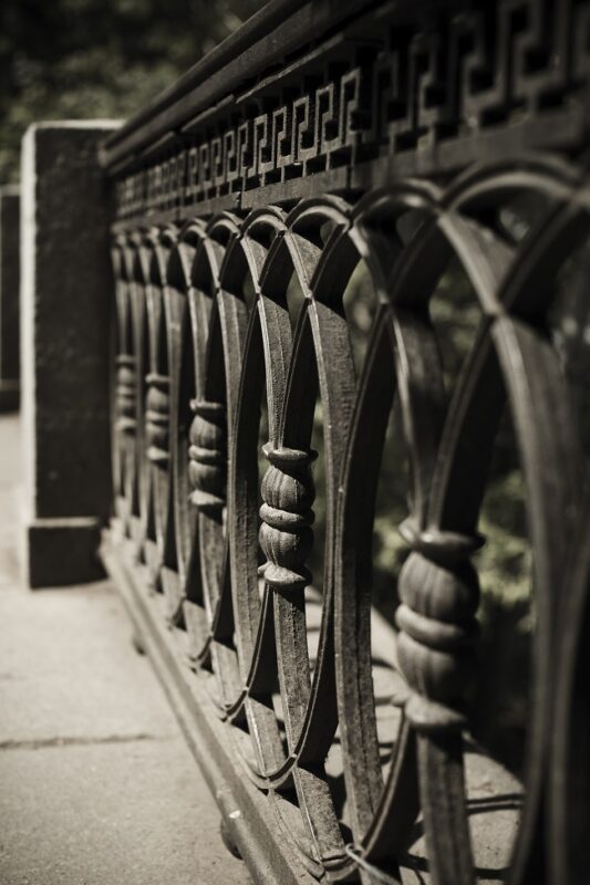 Repainting a Worn-Down Wrought Iron Fence Adds Value